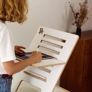 A woman using a modern adjustable standing desk at home, promoting ergonomic workspace solutions.
