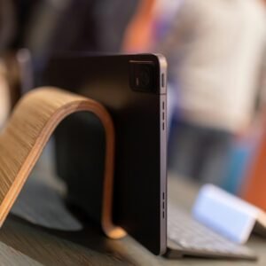 A sleek tablet on a stylish wooden stand with a wireless keyboard, showcasing modern technology and design.
