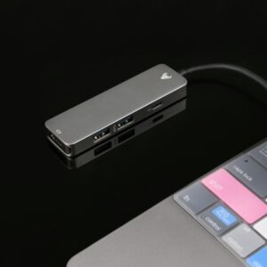 Sleek USB hub connected to a laptop, featuring tech elements on a glossy black surface.